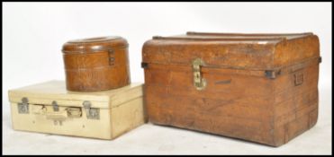 A group of early 20th century vintage luggage to include a vintage grained tin trunk with lock to