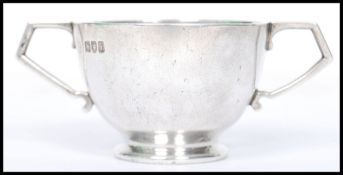 An early 20th century silver hallmarked twin handled cup bearing London hallmarks dating to 1904.