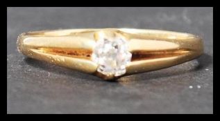 An antique 18ct gold and diamond solitaire ring having a single old cut diamond in a claw setting