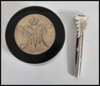 A silver hallmarked button hole together with an ebonised lacquered pill pot / snuff pot having a