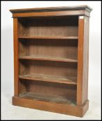 A Victorian oak open window bookcase being raised