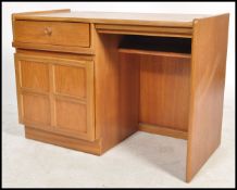 A retro 1970's Nathan furniture teak wood pedestal desk. The open kneehole recess flanked by a qtr