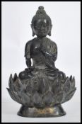 A 19th century Oriental Chinese bronze Buddha modelled in the lotus position raised on a pedestal