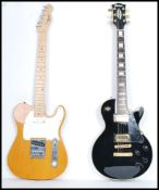 Two 20th century electric six string guitars, one being a Squire stratocaster style guitar