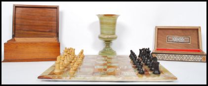 A mid century retro onyx chess board with wooden chess pieces in micro mosaic box together with a