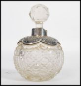 A 19th century Victorian silver hallmarked perfume bottle of globular form. The faceted glass body