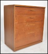 A retro 20th century Danish inspired teak wood chest of drawers. Raised on inset plinth with central
