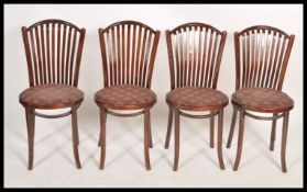 A  set of 4 contemporary retro style bentwood cafe dining chairs raised on turned legs with pad