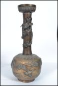 A 19th century Chinese bronze vase embellished with dragons to the tall waisted neck over a