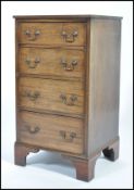 An early 20th century mahoganys square fronted pedestal  chest of four drawers with drop swag