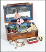 A vintage jewellery box containing a collection of vintage silver and costume jewellery to include