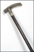 A 19th century Chinese silver walking stick cane. The tapering ebony shaft with silver dragon handle