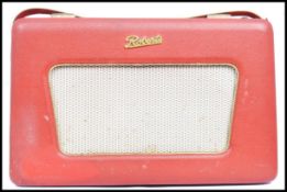 A vintage 20th century 1960's red Roberts radio with handle and dials to top complete with