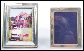 A pair of non matching silver hallmarked easel backed picture frames, each hallmarked to the side.