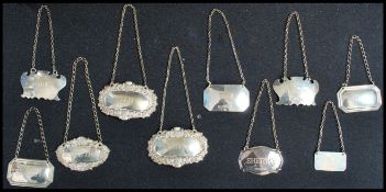 A collection of silver hallmarked decanter labels to include Malt, Brandy, Sherry, Dry, Madeira,