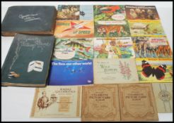 A collection of cigarette cards within 2 vintage albums to include Wills Radio Celebrities,