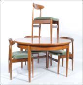 G-Plan - A retro 1960's teak wood extending dining table of round form raised on tapering legs