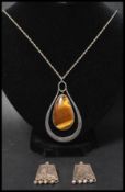 A silver and tigers eye large pendant necklace having a rope twist chain with bolt ring clasp.