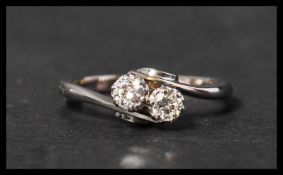 An 18ct white gold and platinum diamond ring having two approx 10pt diamonds in a crossover setting.