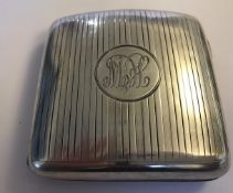 A hallmarked silver engine turned cigarette case with hidden photograph compartment.  The case