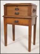 A good Edwardian Arts & Crafts oak cased canteen of cutlery on stand. The stand with squared legs