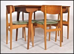 A 1970's retro teak wood dining table having tapering sqaured legs with extending top, the chair