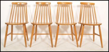A set of four vintage retro mid 20th century Danish influence dining chairs raised on tapering