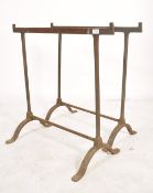 A pair of early 20th century workmens cast metal trestle ends - coffine stands ideal for
