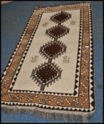 A 20th century Kelim woolen rug / runner , on cream ground with a central medallions, inner border