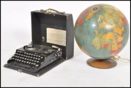 A vintage mid 20th century Encyclopedia Britannia globe raised on circular wooden base along with