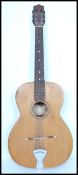 A vintage mid 20th century Italian Estudiantin acoustic guitar. The shaped hollow body having six