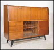 A 1950's - mid century retro sideboard - highboard having a series of fall front cabinets over