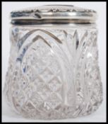 A large early 20th century silver hallmarked topped cut glass dressing table pot. Hallmarked for