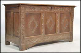 A James 1st oak country coffer being raised on reduced stile supports, 3 fielded panel front with