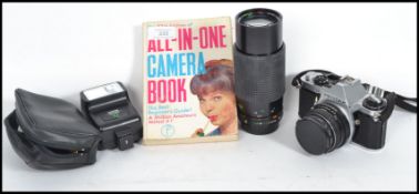 A vintage 20th century Pentax camera with a Sirus lens and flash along with an All in one camera
