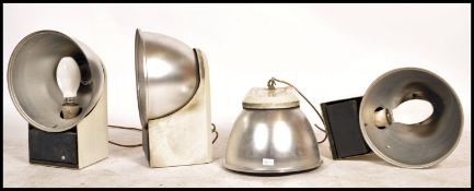 A group of four vintage / retro Industrial 20th century unusual shaped aircraft hanger lights, set