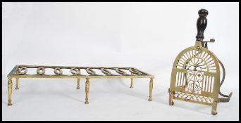 A 19th century brass and iron work trivet of rectangular form having a recurring design to the top