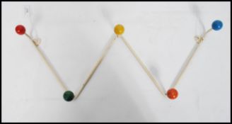 A vintage retro sputnik atomic set of coat hooks in a painted white finish with multi coloured