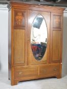 A large Edwardian mahogany double wardrobe being raised on a plinth base with deep drawer. Above a
