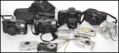 A collection of vintage 20th century  and retro cameras to include Canon EOS, Casio, Fuji, Kodak,