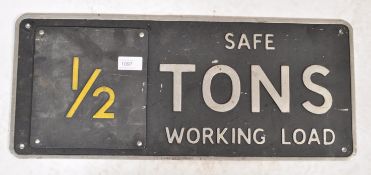 A vintage mid century Industrial cast metal warning sign with notation for ' Safe Tons Working