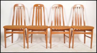 A set of 4 20th century Nathan furniture dining chairs in teak being raised on tapering legs with