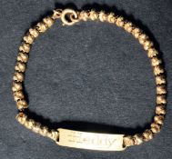 An 18ct gold vintage ladies bracelet chain having ball links with monogrammed name panel and bolt