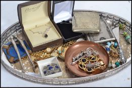 A collection of vintage silver and costume jewellery to include a silver bracelet, charm