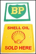 A pair of square vintage style cast metal point of sale advertising garage wall plaques for Shell