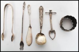 A group of silver hallmarked flatware to include a pickle fork with twist stem and apostle finial, a
