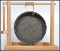 A 20th century wooden framed table / dinner gong, set within a pine wooden frame having a