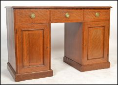 An Edwardian mahogany inlaid twin pedestal office desk. Raised on plinth bases with locker doors and