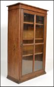 A 19th century Victorian oak bookcase raised on a flared plinth base having a quarter panelled