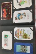 Postcards. Collection in Edwardian album of Christmas Greetings type (300). Mostly antique issues.